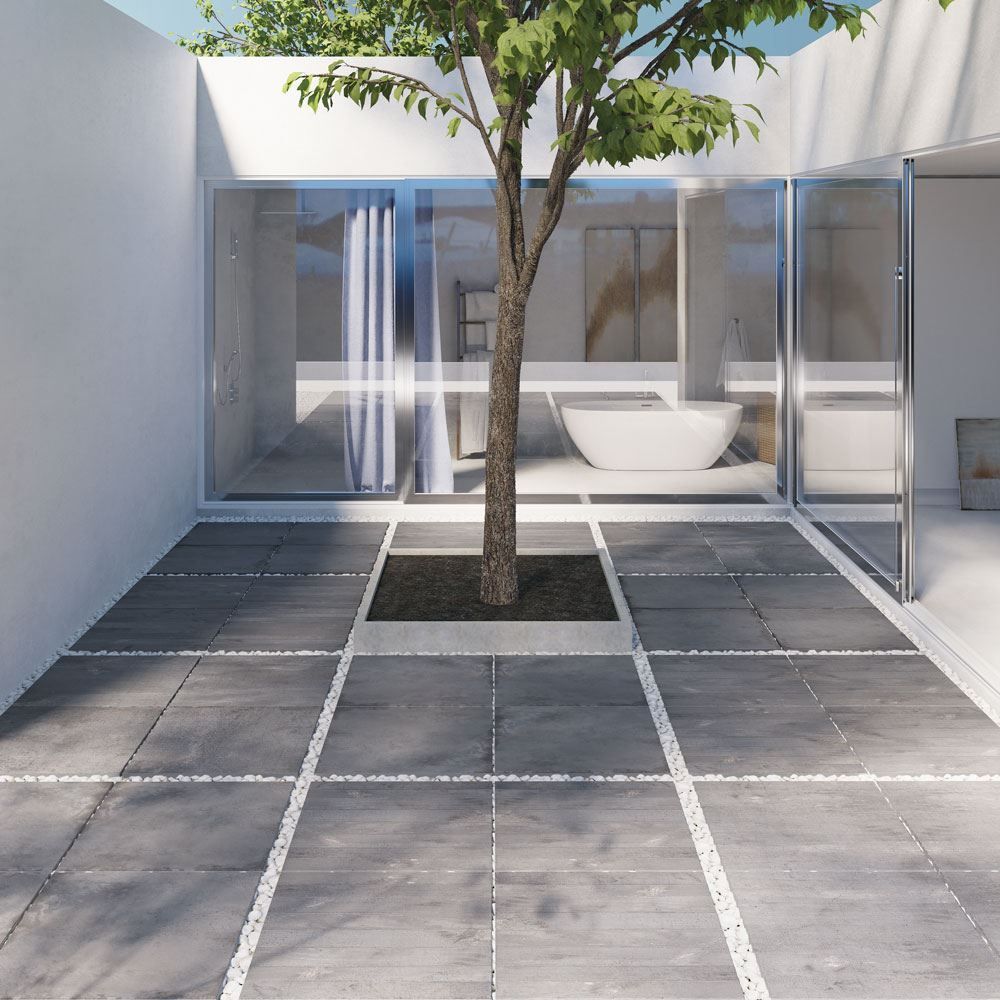 Modern outdoor patio with large format porcelain pavers and contemporary landscaping